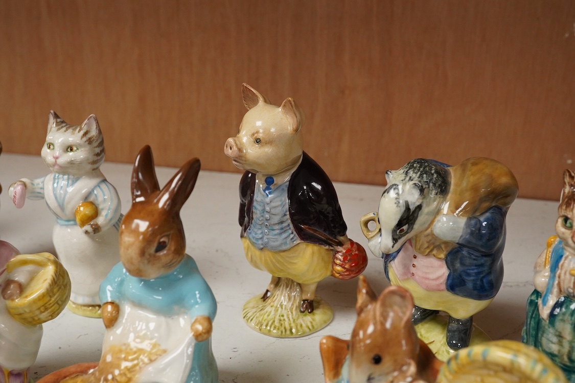 A collection of thirteen Beatrix Potter character figures, stamped with a gold stamp F Warne and Co Ltd, Beswick England, largest 12cm high